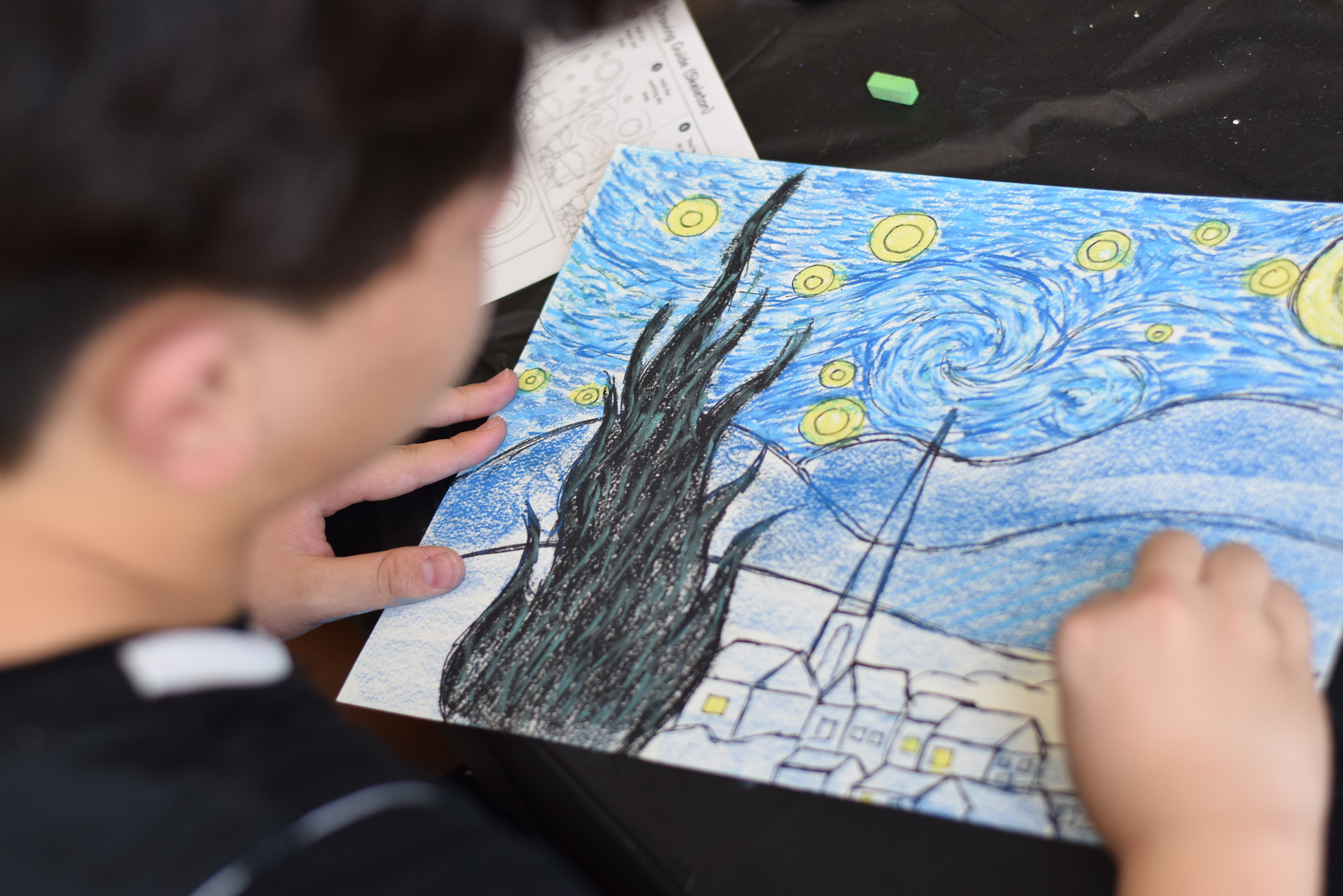 Kid painting a Starry Night art project at an art party