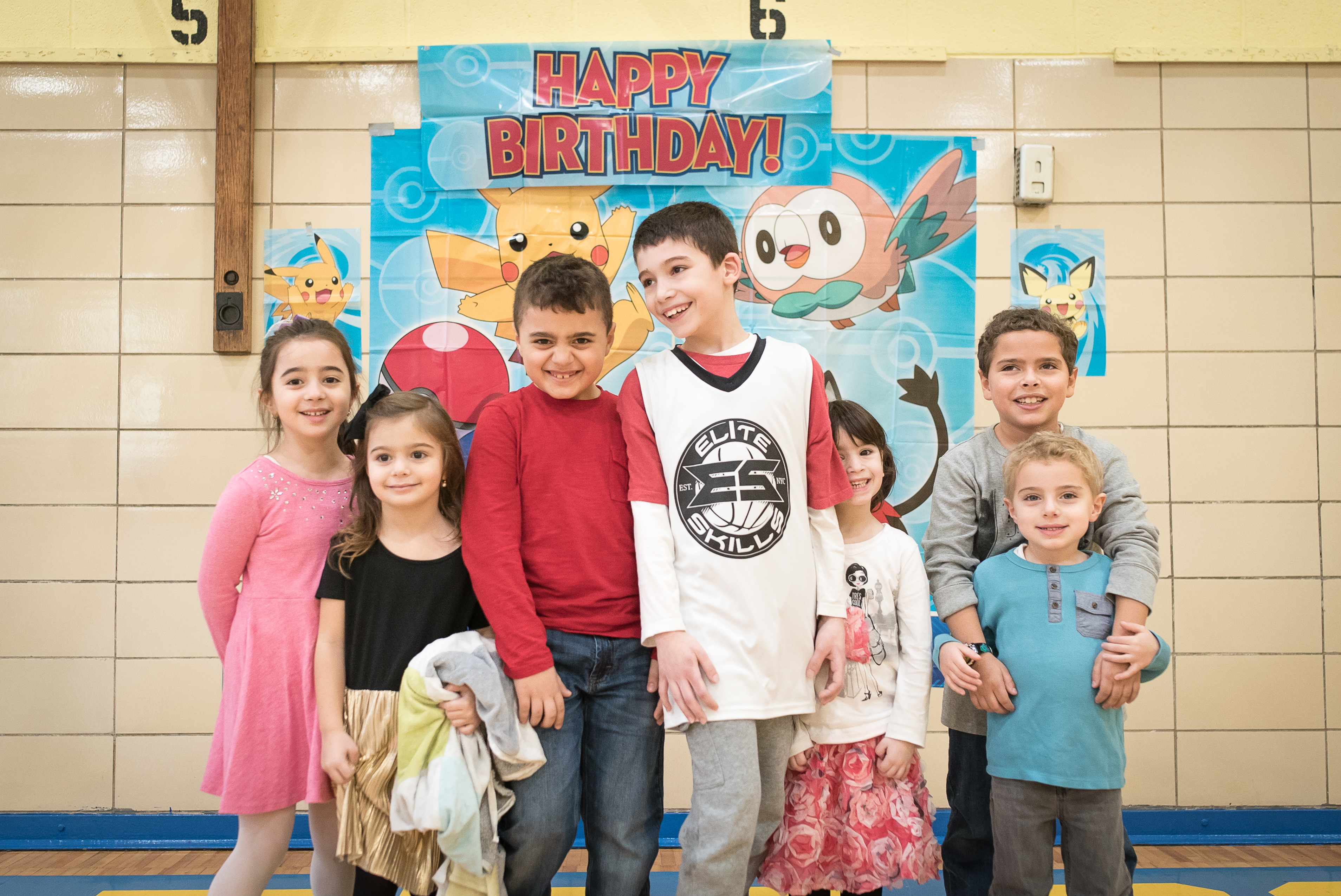 Party group in front of a Happy Birthday banner