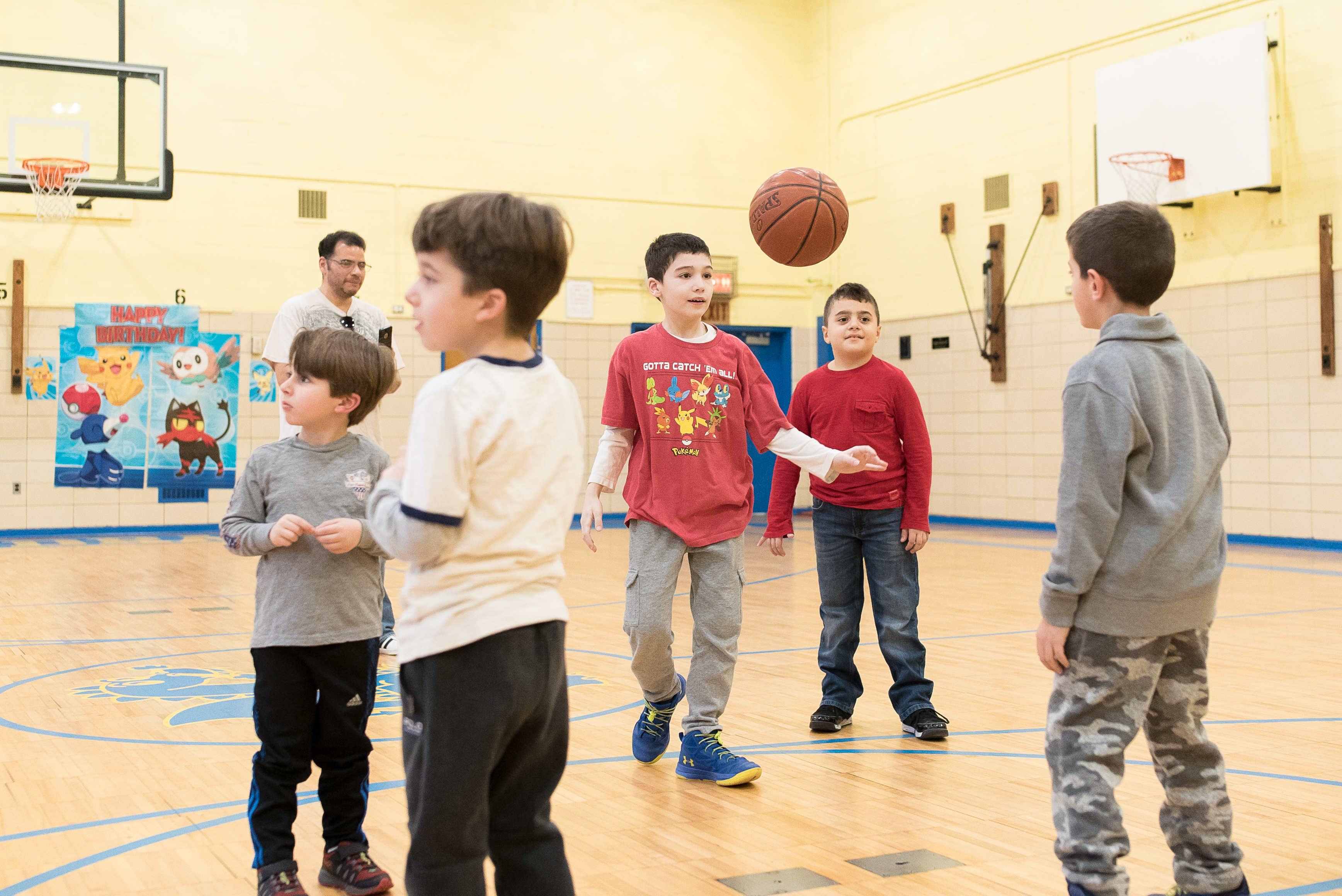 Kids playing basketball together