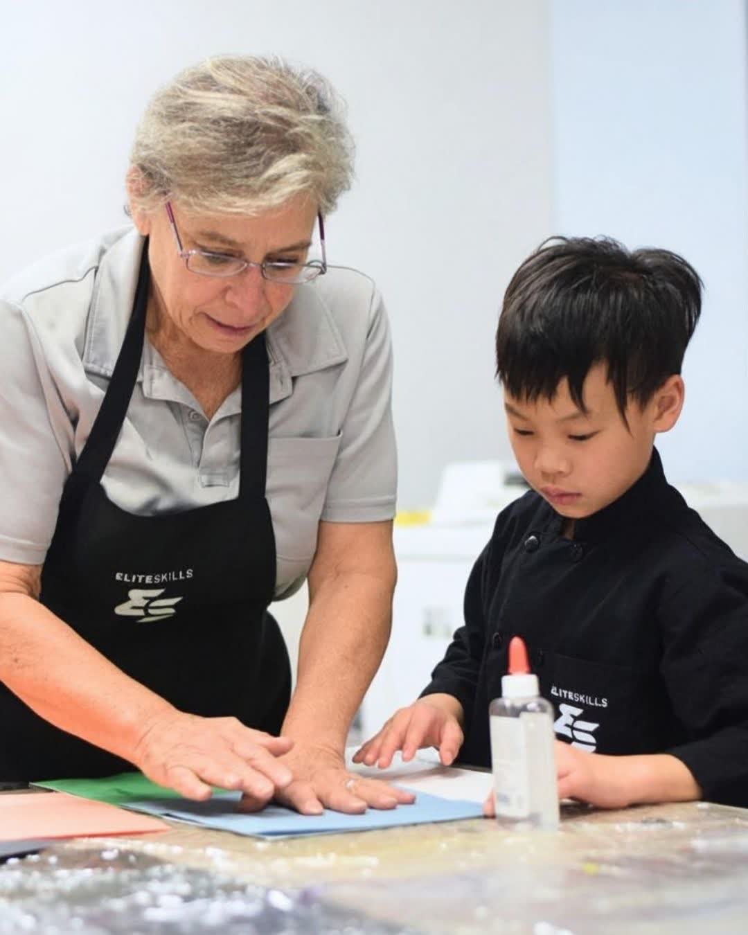 Art instructor working with a camper